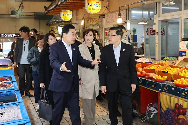주낙영 경주시장이 홍콩 존 리 행정수반에게 중앙시장 내 상점가를 안내하며 전통시장 현황을 설명하고 있다. 경주시 제공