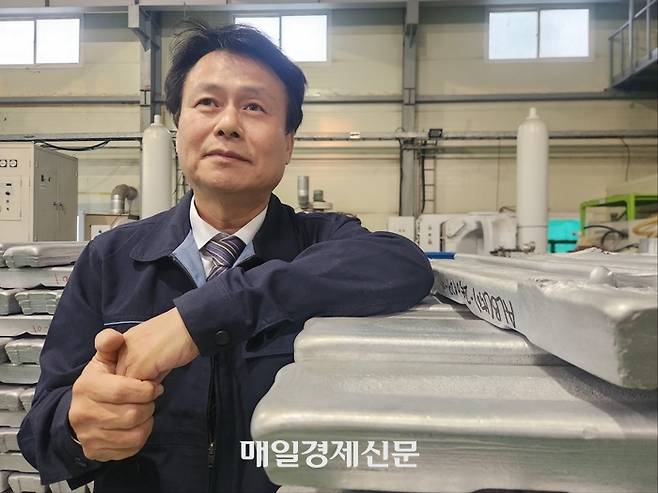 지에이엠 최진철 대표가 고강도 알루미늄 합금 잉곳 옆에서 말하고 있다. 이한나기자