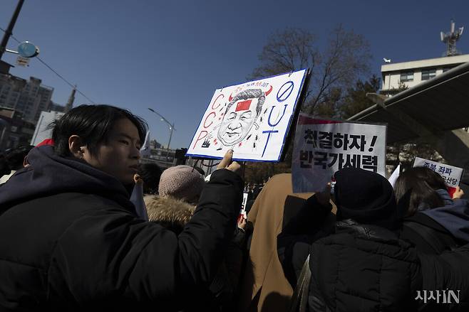 지난 2월24일 숭실대에서 열린 윤석열 탄핵 반대 집회에서 참석자가 시진핑 중국 국가주석의 얼굴이 그려진 피켓을 들고 있다. ⓒ시사IN 이명익