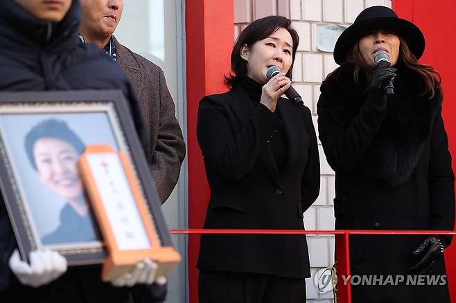 윤석화를 추모하며 '꽃밭에서' (서울=연합뉴스) 강민지 기자 = 21일 서울 종로구 한예극장 앞에서 열린 배우 윤석화의 노제에서 고인의 동료들이 추모곡'꽃밭에서'를 부르고 있다. 2025.12.21 mjkang@yna.co.kr