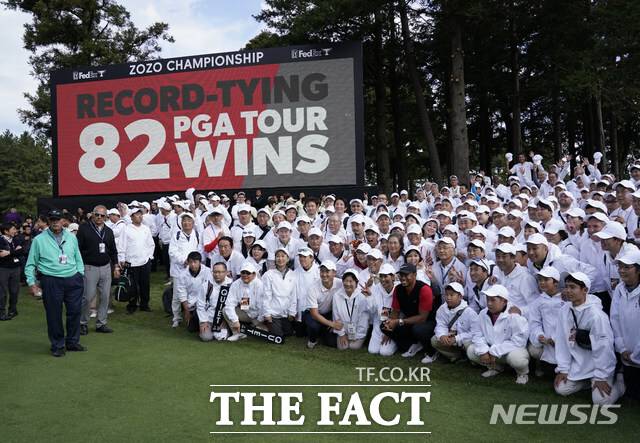 2019년 일본 지바현에서 열린 조조오픈 우승으로 통산 82승을 기록한 타이거 우즈가 자원봉사자들과 함께 기념촬영을 하고 있다./AP.뉴시스