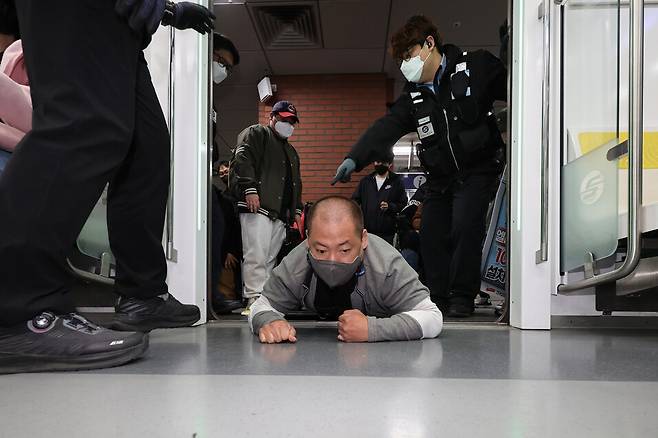 전국장애인차별철폐연대 소속 장애인들이 2022년 4월21일 오전 서울 지하철 2호선 시청역에서 출근길 지하철 오체투지 탑승 시위를 하고 있다. 연합뉴스