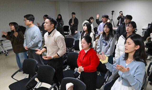 그리스도의몸교회 교인들이 세미나실에서 손을 들고 찬양하는 모습. 신석현 포토그래퍼