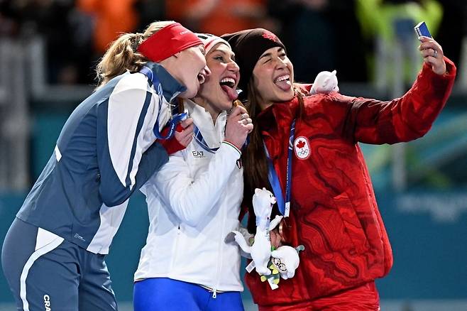 밀라노 코르티나 2026 동계 올림픽 스피드 스케이팅 여자 3000m 은메달리스트 노르웨이의 라그네 비클룬드(왼쪽부터), 금메달리스트 이탈리아의 프란체스카 롤로브리지다, 동메달리스트 캐나다의 발레리 몰타이스가 7일 밀라노의 밀라노 스피드 스케이팅 스타디움에서 열린 시상대에서 셀카 포즈를 취하고 있다. 사진=AFP