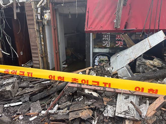 화재가 발생한 상가의 1층 한식당 입구의 모습. 화재로 타서 무너진 2층의 잔해들이 떨어져 주변이 어질러져 있다. 정주원 기자