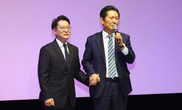 정청래(오른쪽) 더불어민주당 대표가 2일 인천 계양구 경인교육대학교에서 열린 김남준 전 청와대 대변인 '쉬운 정치, 김남준' 북콘서트에서 김 전 대변인의 손을 잡고 축사하고 있다. 연합뉴스