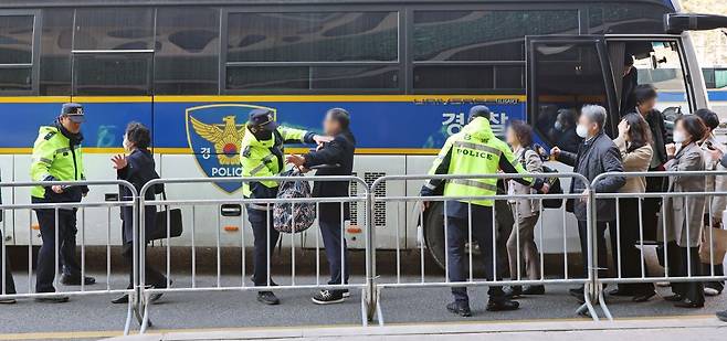 룹 방탄소년단(BTS) 컴백 공연이 열리는 21일 오후 서울 중구 서울광장 인근에서 공연장 주변 결혼식 하객들이 경찰 기동대 버스에서 내려 핸드스캐너 검사를 받고 있다. 뉴시스