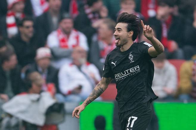 Gladbach's Jens Castrop celebrates after scoring his side's third goal during the German Bundesliga soccer match between 1. FC Cologne and Borussia Moenchengladbach in Cologne, Germany, Saturday, March 21, 2026. (Marius Becker/dpa via AP)