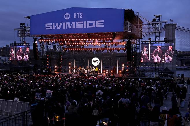 BTS and Suki Waterhouse speak onstage during "Spotify x BTS: Swimside" held at Pier 17 in New York on Monday. (Getty Images for Spotify)