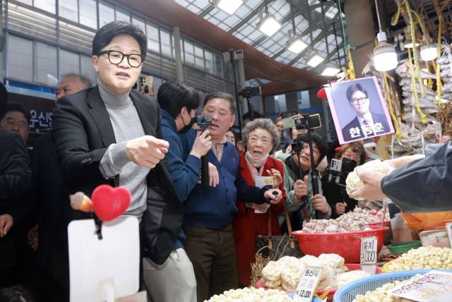 국민의힘 한동훈 전 대표가 지난 22일 서울 동대문구 경동시장을 방문해 마늘을 구매하고 있다. 연합뉴스