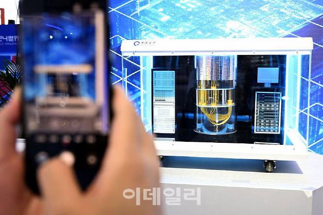 한 관람객이 2024년 9월 20일 안후이(安徽)성 허페이(合肥)시에서 열린 2024 세계제조업대회에 전시된 초전도 양자컴퓨터 번위안우쿵(本源悟空)을 휴대전화에 담고 있다. (사진=신화통신)