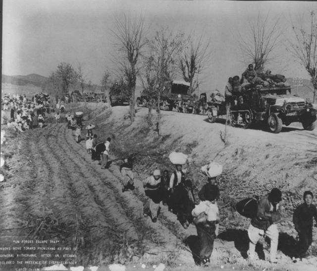 미8군 병력이 좁은 도로를 이용해 평양 방면으로 철수 중인 장면. 1950년 11월 말 경으로 추정된다. 피란민들은 도로를 이용하지 못해 길 옆 논을 따라 대피 중이다. 해리 트루먼 도서관