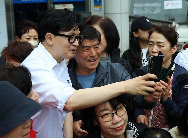 한동훈 전 국민의힘 대표(왼쪽)가 14일 부산 북구 만덕2동 행정복지센터를 방문해 전입신고를 마친 뒤 지지자들과 사진을 찍고 있다.부산=연합뉴스