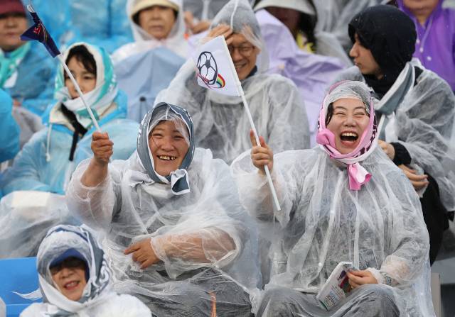 ▲20일 수원 장안구 수원종합운동장에서 열린 아시아축구연맹(AFC) 여자 챔피언스리그(AWCL) 4강 수원FC 위민과 내고향여자축구단의 경기.왼쪽은 수원FC위민, 오른쪽은 내고향축구단의 앰블럼이 인쇄된 깃발을 흔들며 응원하고 있다. ⓒ연합뉴스