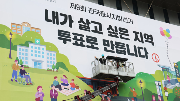 지난 4월9일 경기도 수원시 영통구 경기도선거관리위원회에서 관계자들이 투표 참여 홍보 현수막을 설치하고 있다. 연합뉴스