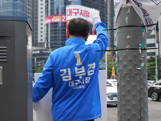 더불어민주당 김부겸 대구시장 후보가 14일 오전 수성구 범어네거리에서 출근길 차량들을 향해 인사를 하고 있다. <영남일보DB>