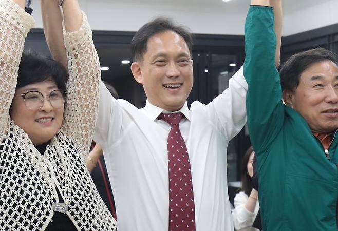 김태규 울산 남구갑 국회의원 보궐선거 국민의힘 후보가 4일 울산 남구 소재 자신의 선거캠프에서 당선이 확실시 되자 지지자들과 손을 맞잡고 환호하고 있다. 뉴스1