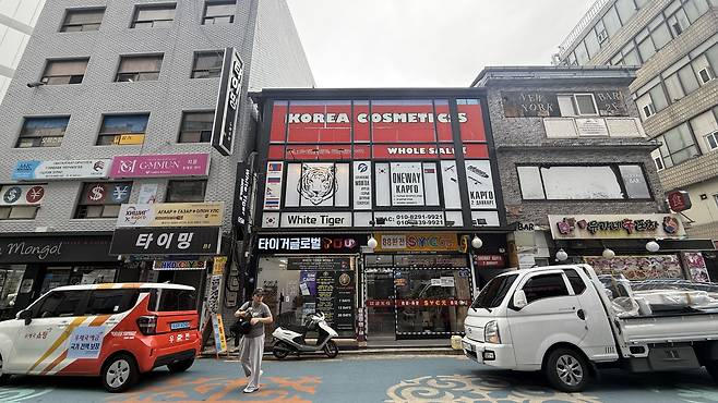 A building houses a mobile phone store and a cargo company. WOO JI-WON