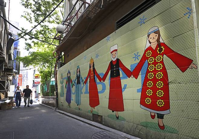 A mural of children in Central Asian attire PARK SANG-MOON