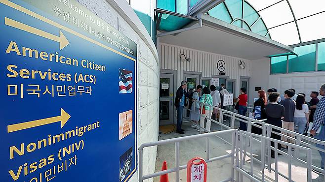 People wait in line for visa interviews outside the U.S. Embassy in Jongno District, central Seoul, on June 5. NEWS1