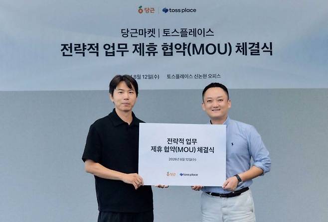 12일 서울 서초구 토스플레이스 신논현 오피스에서 열린 전략적 업무 제휴 협약 체결식에서 박정빈 당근 로컬비즈니스 사업개발 리드와 진필규 토스플레이스 사업부문장이 기념 촬영을 하고 있다. 당근