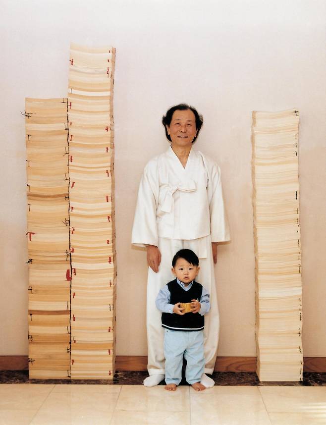 조정래 작가가 손자(조재면)와 함께 대하소설 3부작 육필 원고 사이에 섰다. 왼쪽부터 '태백산맥' '아리랑' '한강' 원고. 한국일보 자료사진