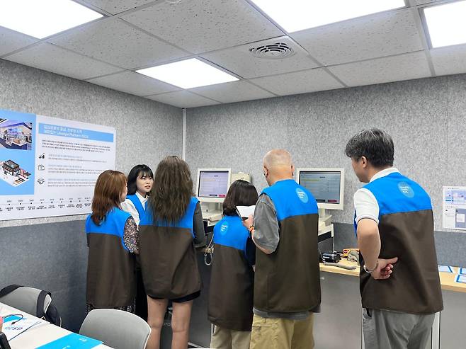 21일 서울 성동구 GS25 행당신동아점에서 'GS25 액티브 시니어 창업 체험' 프로그램을 진행한 전유경 교육담당 매니저가 판매관리시스템 단말기(POS) 사용법을 알려주고 있다. GS리테일 제공