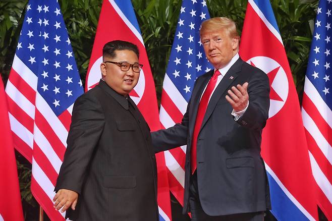 U.S. President Donald Trump, right, and North Korean leader Kim Jong-un meet at the start of a historic summit at the Capella Hotel on Sentosa Island, Singapore, on June 12, 2018. The summit marks the first meeting between an incumbent U.S. President and a North Korean leader. EPA/YONHAP