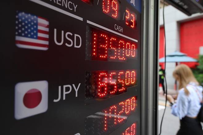 23일 서울 명동의 한 환전소 앞을 관광객들이 지나고 있다. 뉴시스